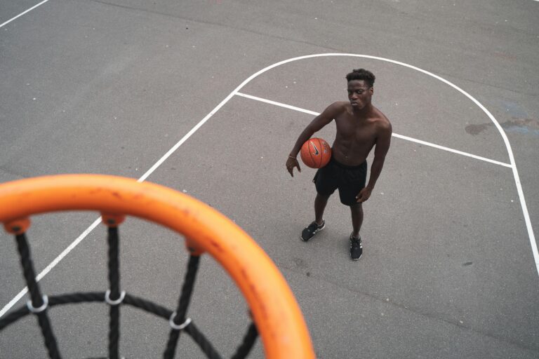Aerial view of a basketball player holding a ball on an outdoor court.